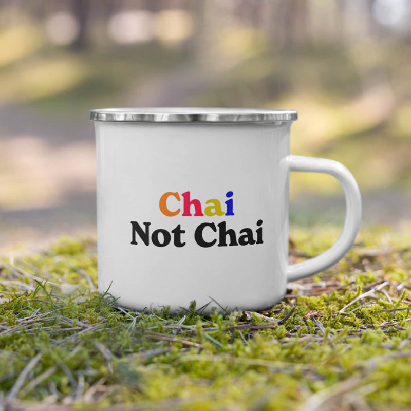 chai not chai חי לא חי enamel mug shown in nature setting on grass with bokeh trees in background
