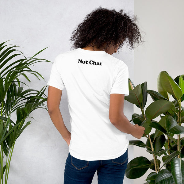 chai not chai חי לא חי t-shirt on model who's standing between two ferns. back imprint shows the words "not chai" in black