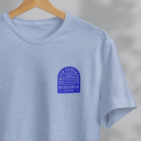 closeup of a light blue shirt with a design in blue that reads "jewish geography research center"