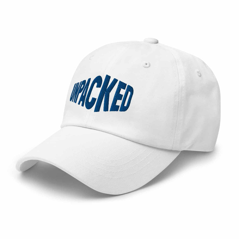 white dad hat with the Unpacked brand logo sewn in blue thread