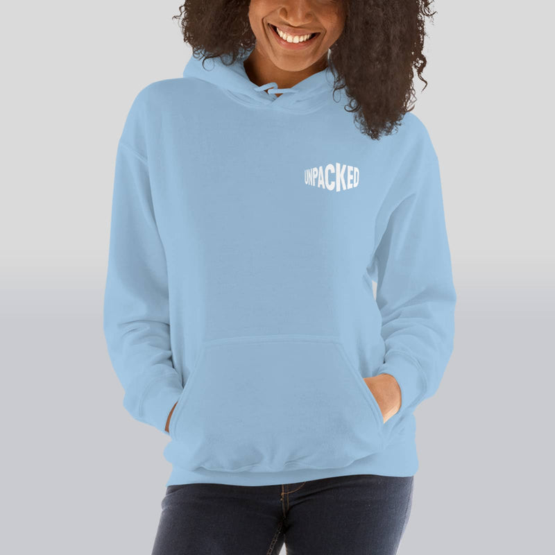 female model wearing a light blue plush hoodie with the Unpacked brand logo in white printed small onto the pocket area