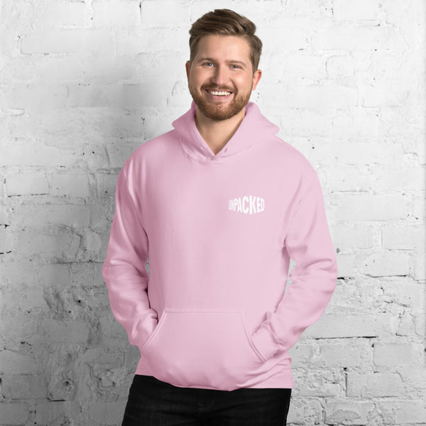 male model wearing a pink plush hoodie with the Unpacked brand logo in white printed small onto the pocket area