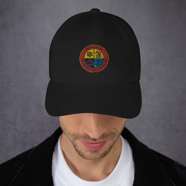 model wearing the black "menorah search and rescue" dad hat